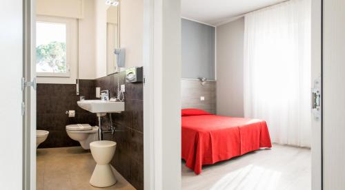 a bathroom with a red bed and a sink at Hotel Al Prato in Padova