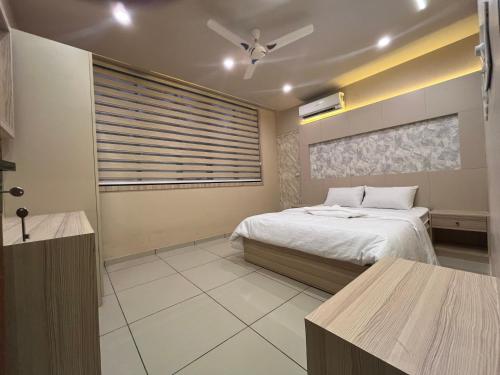 a bedroom with a bed and a ceiling fan at Famstay and healthclub in Kannur