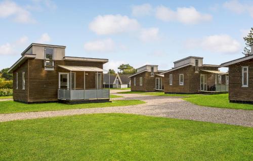 a row of houses in a yard with grass at Beautiful Home In Vestervig With Wifi in Vestervig