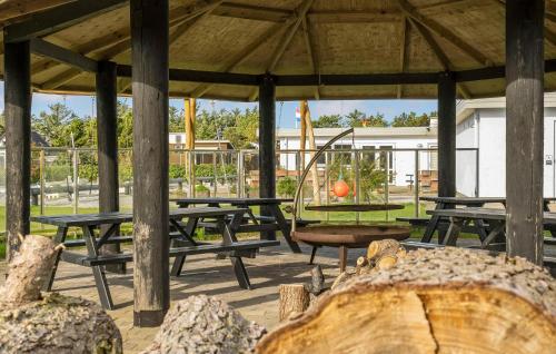a picnic shelter with picnic tables and a swing at Beautiful Home In Vestervig With Wifi in Vestervig