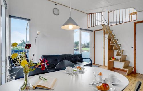 a living room with a table with a vase of flowers at Beautiful Home In Vestervig With Wifi in Vestervig
