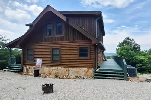 a log house with a porch and a driveway at Serenity Now in New Tazewell
