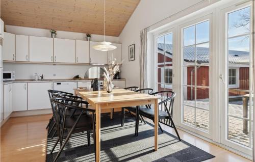 a kitchen and dining room with a wooden table and chairs at Pet Friendly Home In Gråsten With Wifi in Gråsten
