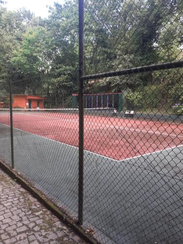 a chain link fence on a tennis court at Cabana da Oliveira in Marco de Canavezes