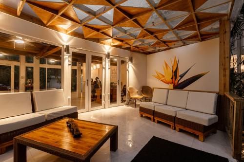 a living room with a couch and a table at Paradise Beach Hotel & Resort in West Bay