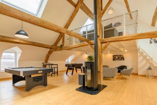 a living room with a ping pong table in a loft at Gîte des dix potiers in Raucourt-et-Flaba