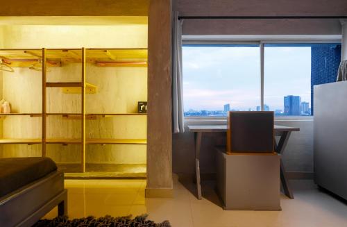 a room with a bed and a desk and a window at Sixteen By Sixteen in Lagos
