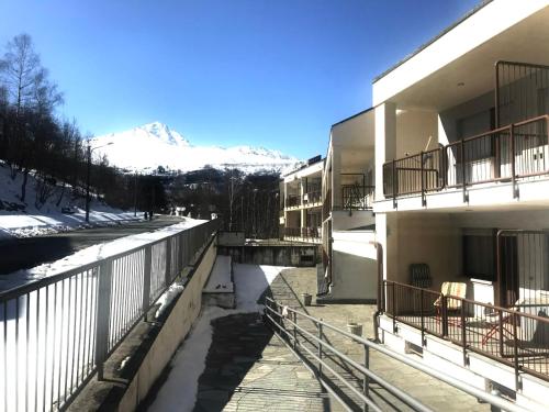 a building with a snow covered mountain in the background at Berto’s House in Montoso