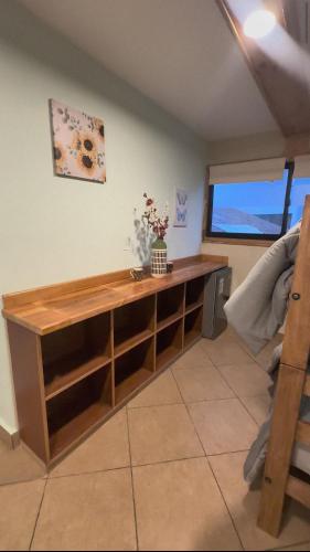 a wooden desk in a room with a window at hostal flor de viña del mar in Viña del Mar