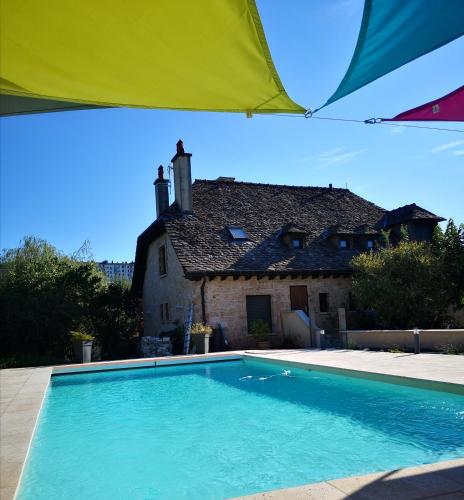 une grande piscine devant une maison dans l'établissement Le Plouf des Gargouilles, à Onet le Château