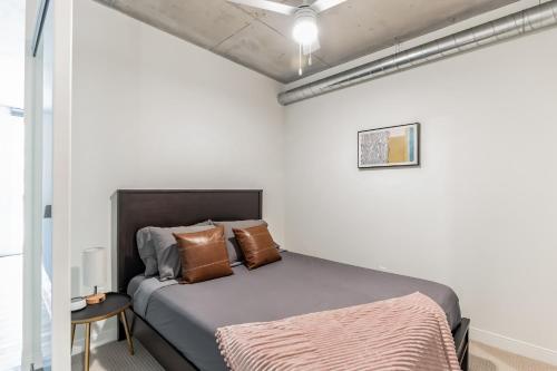 a bedroom with a bed in a white room at DT Delight Downtown Living One-bedroom Endless Access in Cleveland