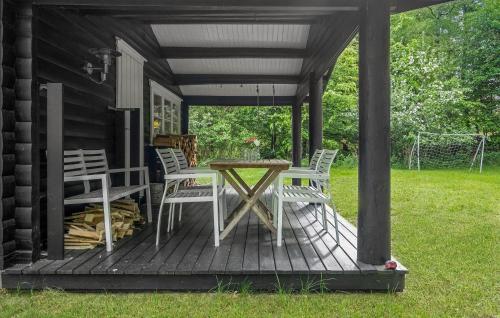 a porch with a table and chairs on a house at 3 Bedroom Cozy Home In Frederiksværk in Frederiksværk