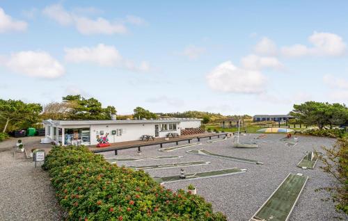 a park with a building and a playground at 1 Bedroom Awesome Home In Vestervig in Vestervig