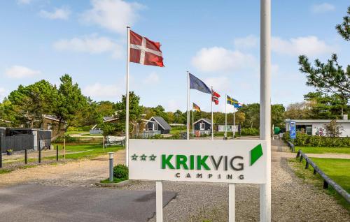 a sign in front of a yard with flags at 1 Bedroom Awesome Home In Vestervig in Vestervig