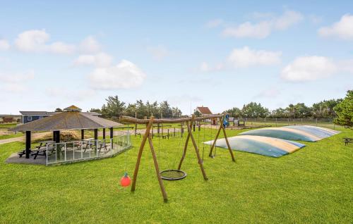 a park with a playground with a swing set at 1 Bedroom Awesome Home In Vestervig in Vestervig