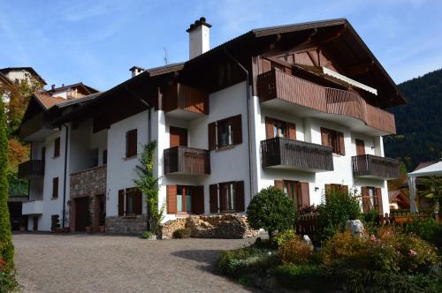 a large white building with balconies on it at VillaGiardino - Lake in Molveno