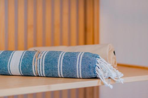 a blue and white striped towel on a shelf at Villas Maher Two in Vasilítsion