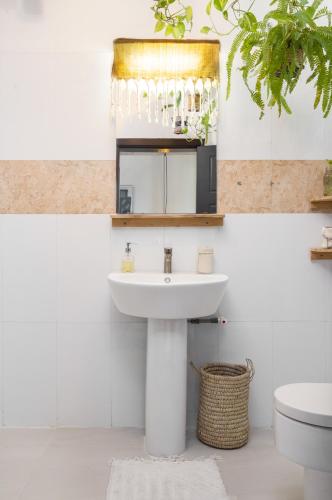 a bathroom with a sink and a toilet at Sixteen By Sixteen in Lagos