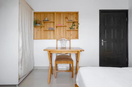 a bedroom with a table and a chair and a bed at Sixteen By Sixteen in Lagos