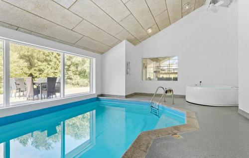 a swimming pool in a bathroom with a tub and a bath tub at Cozy Home In Hirtshals With Kitchen in Hirtshals
