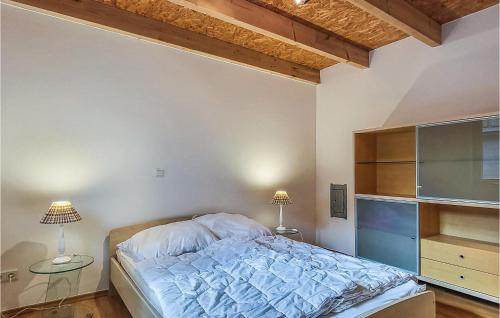 a bedroom with a bed and two lamps in it at Lovely Home In Wittstock With Kitchen in Wittstock