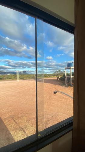 a window with a view of a soccer field at Hotel Capivara in Mucugê