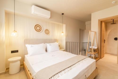 a bedroom with a large white bed with white pillows at ADORNO PRIVATE SUITES Only Adults & Kids 12 Plus in Nea Vrasna
