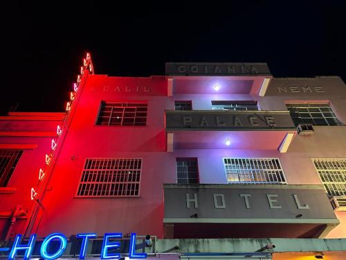 a hotel is lit up in red and white at Hotel Goiânia Palace in Goiânia