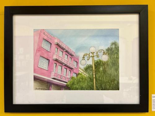 a painting of a pink building and a street light at Hotel Goiânia Palace in Goiânia