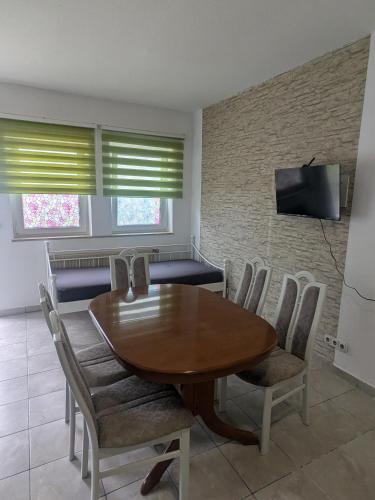 a dining room with a wooden table and chairs at Ferienwohnung J10, Playmobil Funpark Zirndorf Nürnberg in Zirndorf