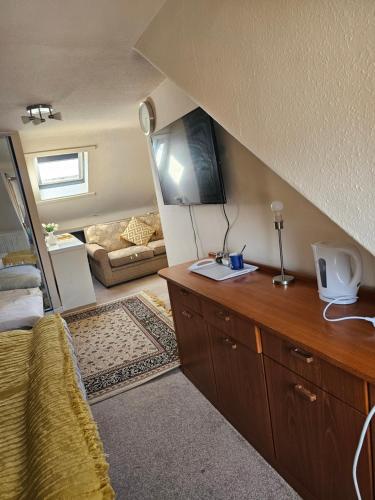 a living room with a couch and a table in a room at 89 Clerk Street in Loanhead
