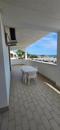 a white table on the balcony of a building at Appartamenti Bramante in Vieste