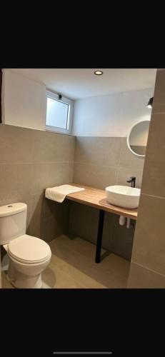 a bathroom with a toilet and a sink at Calavato Cottage in Kalavasos