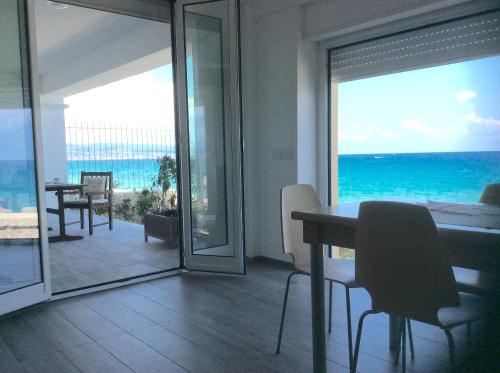 a dining room with a view of the ocean at Marina Holiday Home in Pizzo