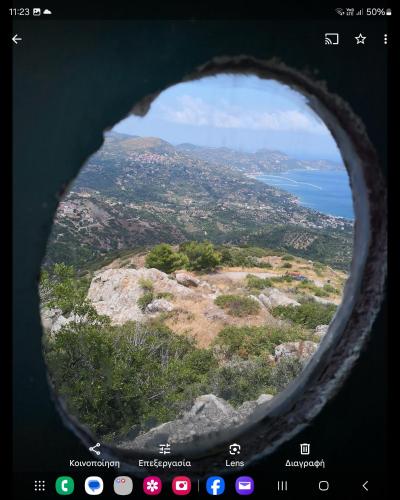 a view from the inside of a window of an airplane at The Aegean balcony in Enoría