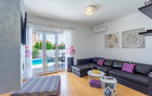 a living room with a couch and a table at Beautiful Home In Pula in Pula