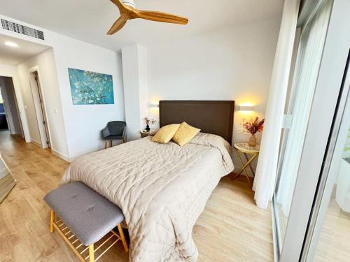 a bedroom with a large bed and a ceiling fan at PUSHE Playa Granada Beach & Golf 31 in Motril