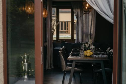 a dining room with a table with food on it at ANDO Villa with wood stove sauna in Selgas