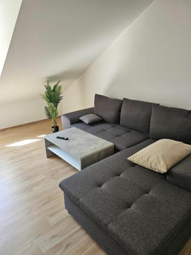 a living room with a couch and a table at Ferienwohnung 55qm Mörnsheim in Mörnsheim