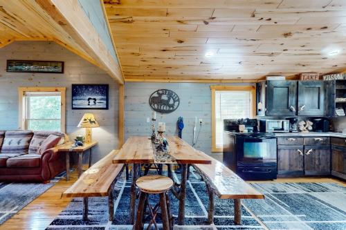 a kitchen with a wooden table in a cabin at The Korn Krib- Main level in Oxbo