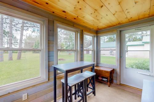 a tiny house with a table and two stools at The Korn Krib- Main level in Oxbo