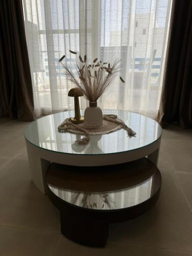 a glass table with a vase on top of it at 3BR Chalet in MV Ras El Hekma in Ras Elhekma