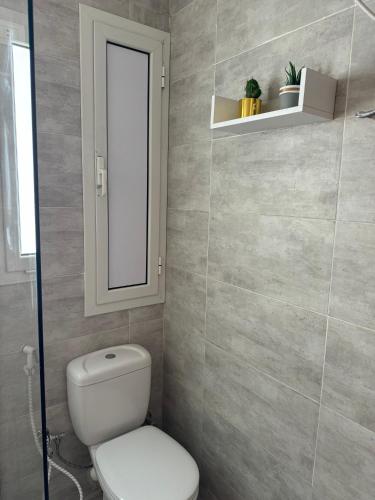 a bathroom with a white toilet and a mirror at 3BR Chalet in MV Ras El Hekma in Ras Elhekma