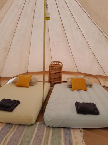 two beds in a teepee tent with at Cuckoo Lake Forest Cabin in Saint-Vincent-Jalmoutiers