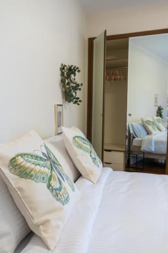 a bedroom with a bed with two pillows on it at GRAND SUITE by F & G in Kastoria