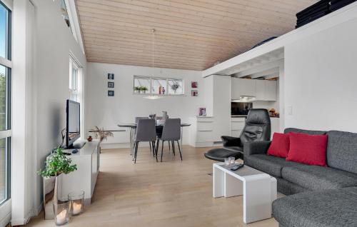 a living room with a couch and a table at 3 Bedroom Amazing Home In Mariager in Mariager