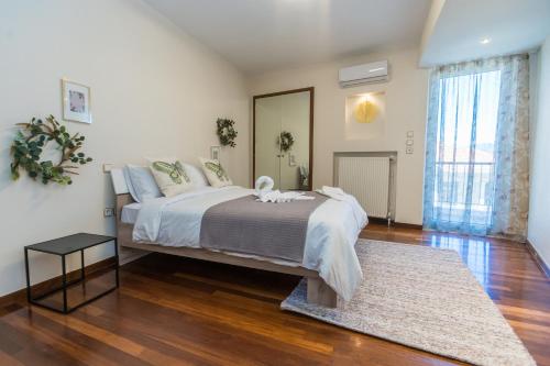 a bedroom with a large bed and a rug at GRAND SUITE by F & G in Kastoria