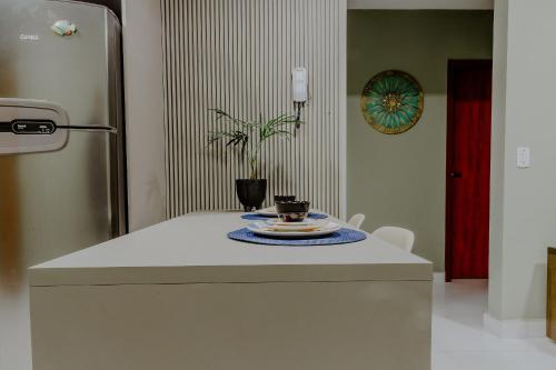a kitchen with a refrigerator and a plate on a counter at Bee Guest - Apartamentos de Temporada Luxxor Flat in Cuiabá