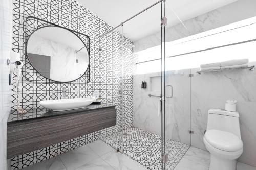 a white bathroom with a sink and a mirror at Hotel Estancia Business Class in Guadalajara
