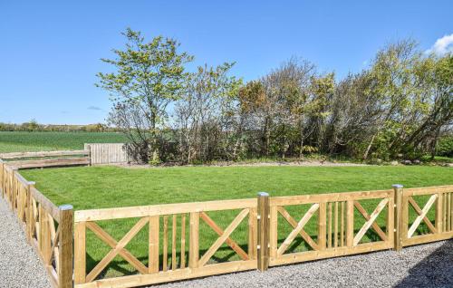 a wooden fence in front of a field at Krukken in Vang